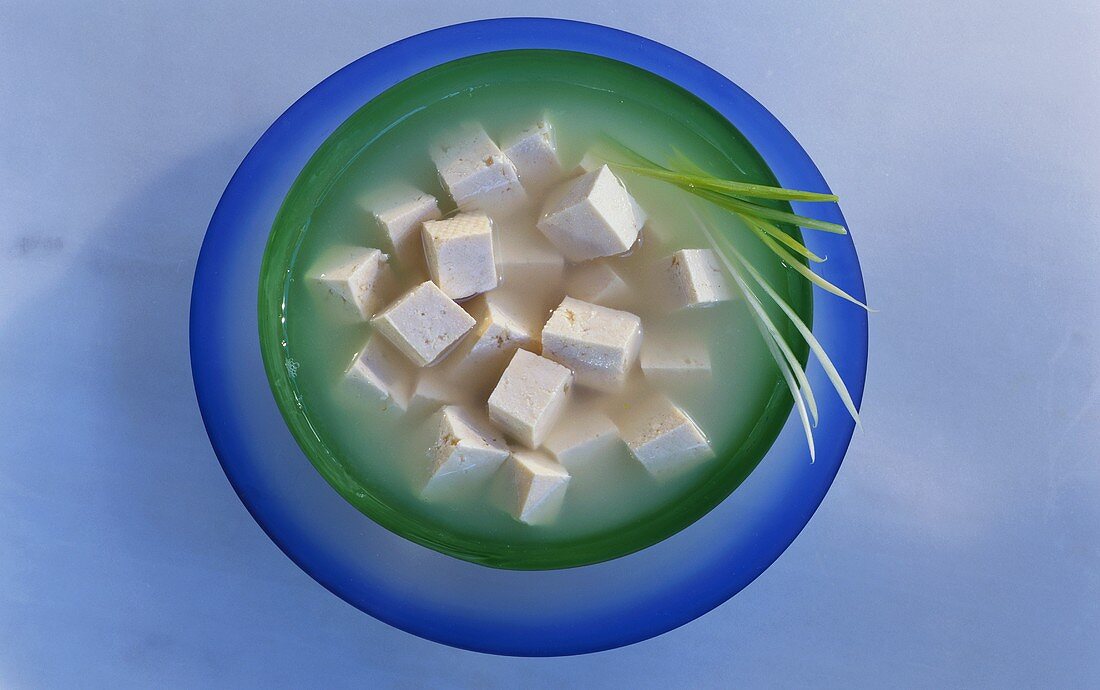 Tofu cube with liquid in a dish