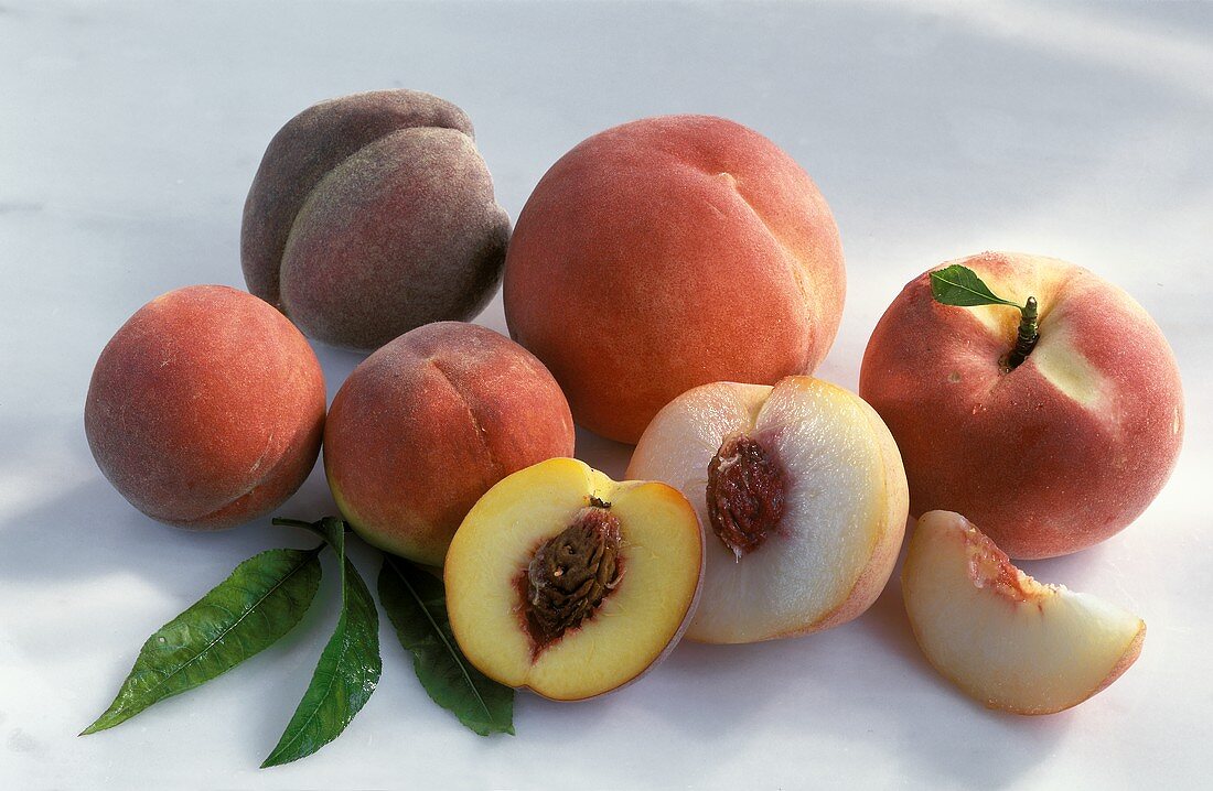 Various types of peach, whole and cut open