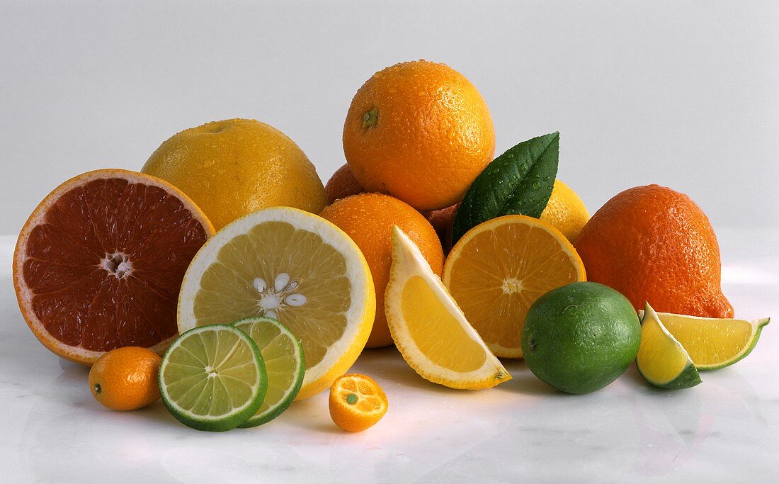 Various citrus fruits, whole and sliced