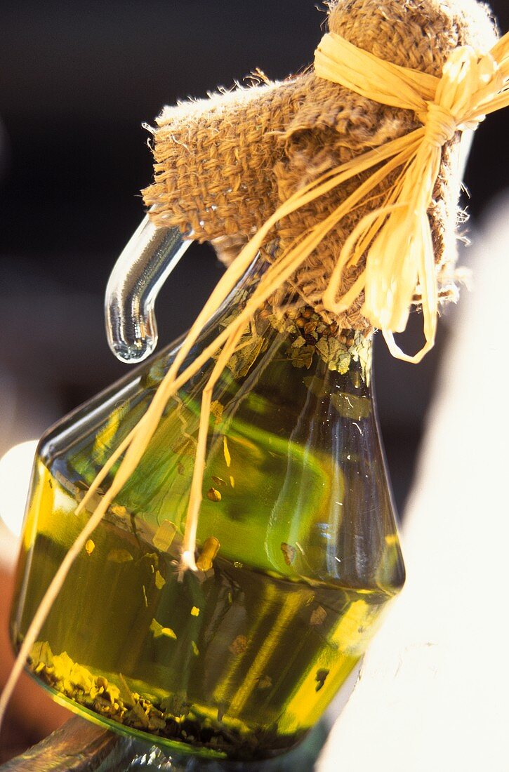 Olive oil in bottle, tied up with jute
