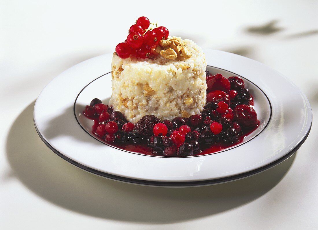 Walnut rice with hot berries on white plate