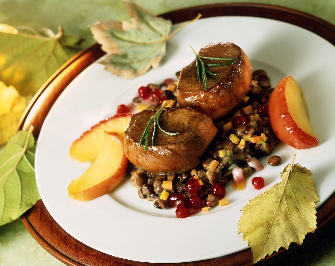 Venison steaks with bacon lentils,apple slices & cranberries