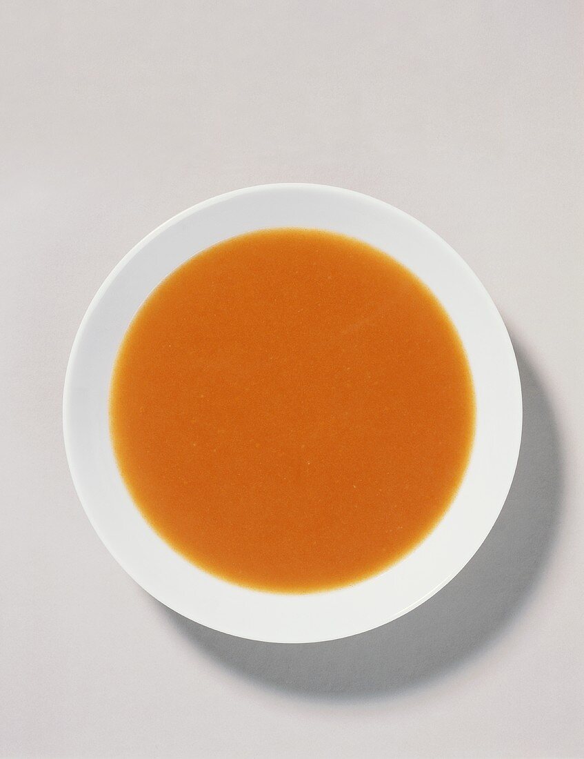 Tomato soup on white plate