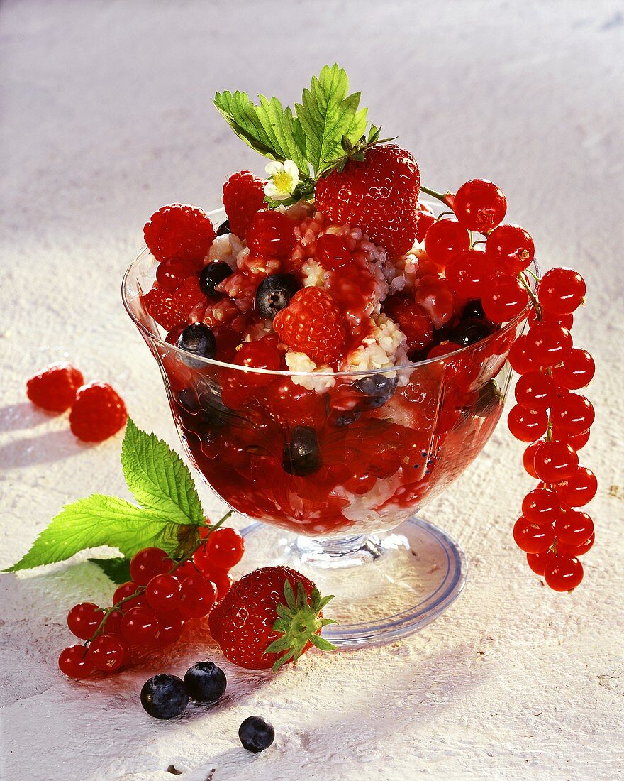 Mixed berries with buckwheat pudding in glass bowl