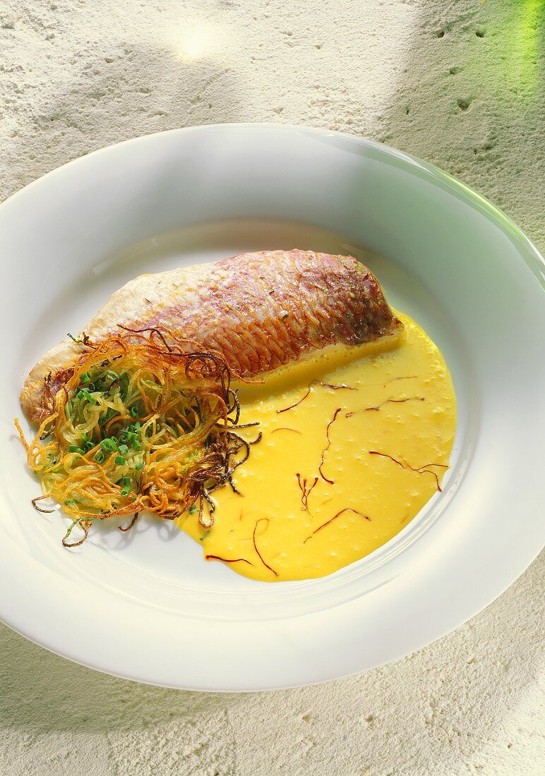 Red mullet on saffron sauce with vegetable spaghetti