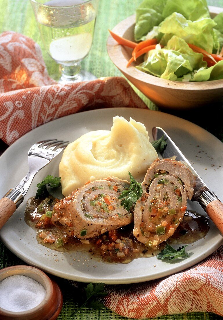 Pork rolls with vegetable stuffing and mashed potato; salad