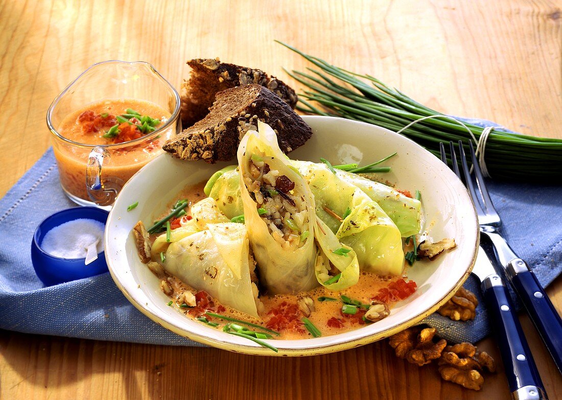 Cabbage roulades with nut rice & pepper cream on plate