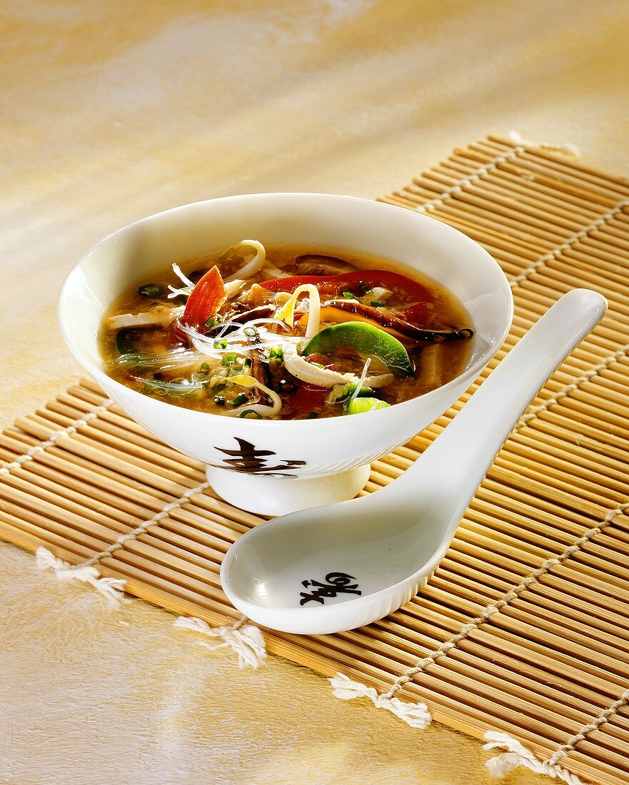 Sweet and sour vegetable soup with glass noodles and tofu