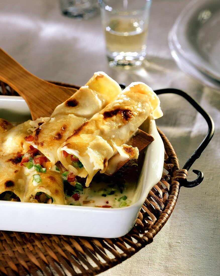Cannelloni with pepper and onion stuffing and parmesan sauce