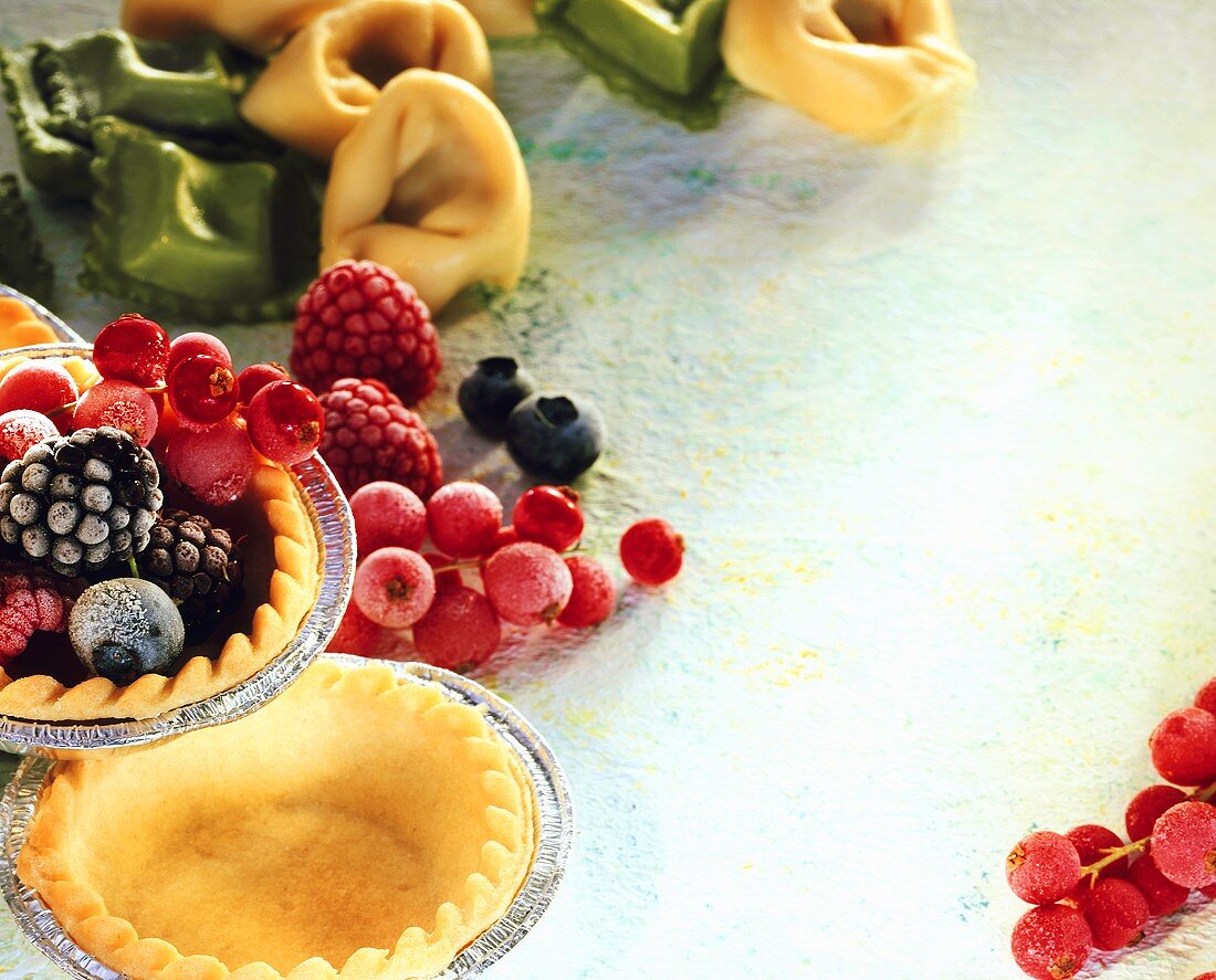 Still life with pastry, frozen berries, ravioli & tortellini