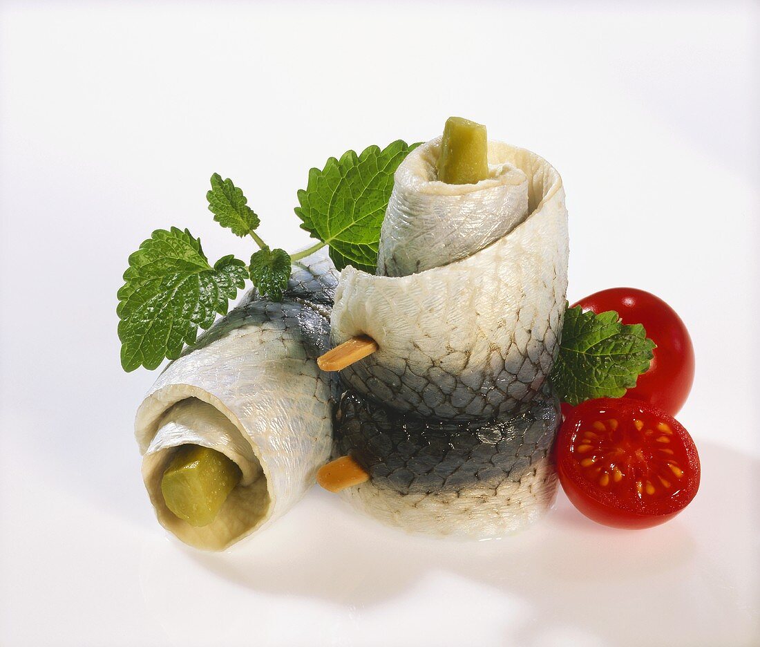 Rollmops with mint leaves and cherry tomatoes