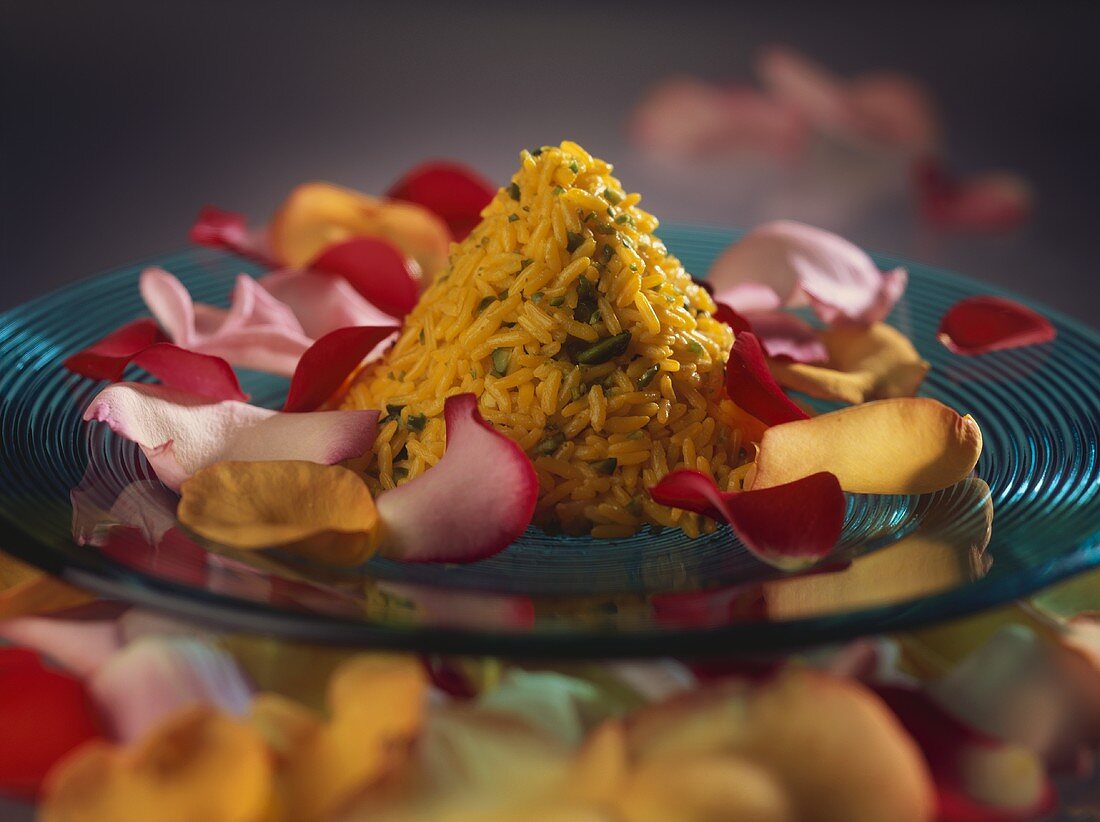 Rice pyramid with pistachios, surrounded by rose petals