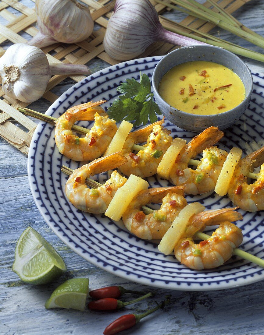 Shrimp kebabs with pineapple and dip on plate