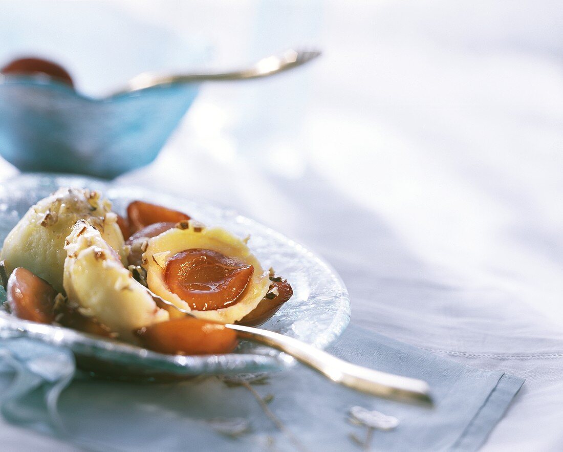 Damson dumplings with chopped hazelnuts on plate