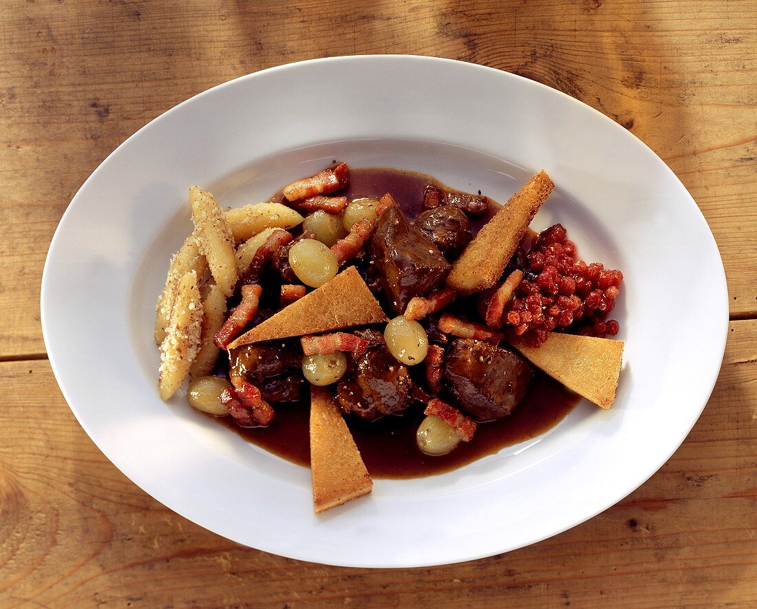 Venison ragout with grapes, bacon, croutons & potato noodles