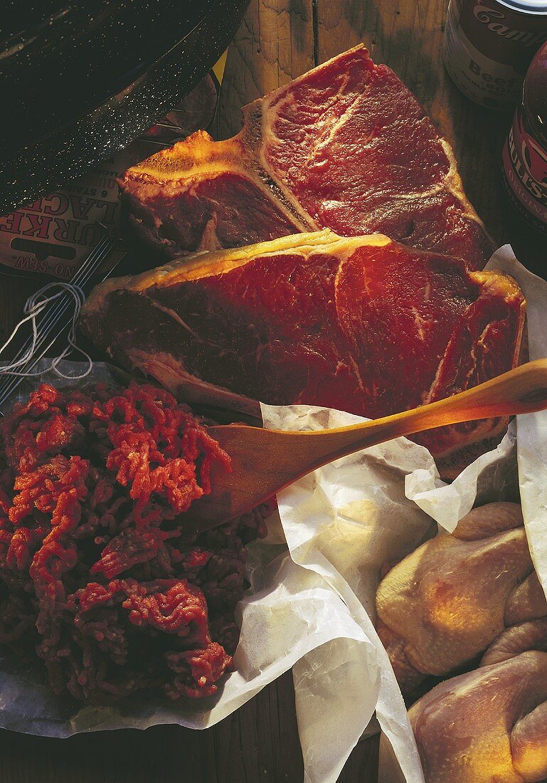 Still life with minced beef, two beefsteaks & poultry