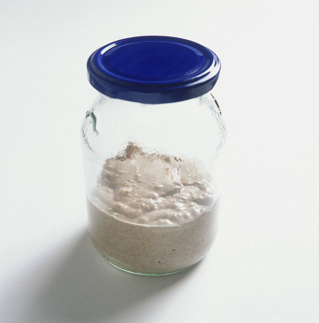 Sourdough in a jar with blue lid