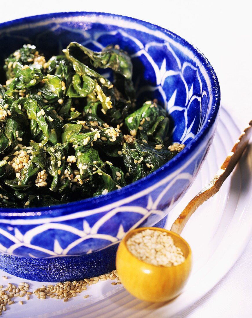 Sesame spinach in blue and white bowl on plate