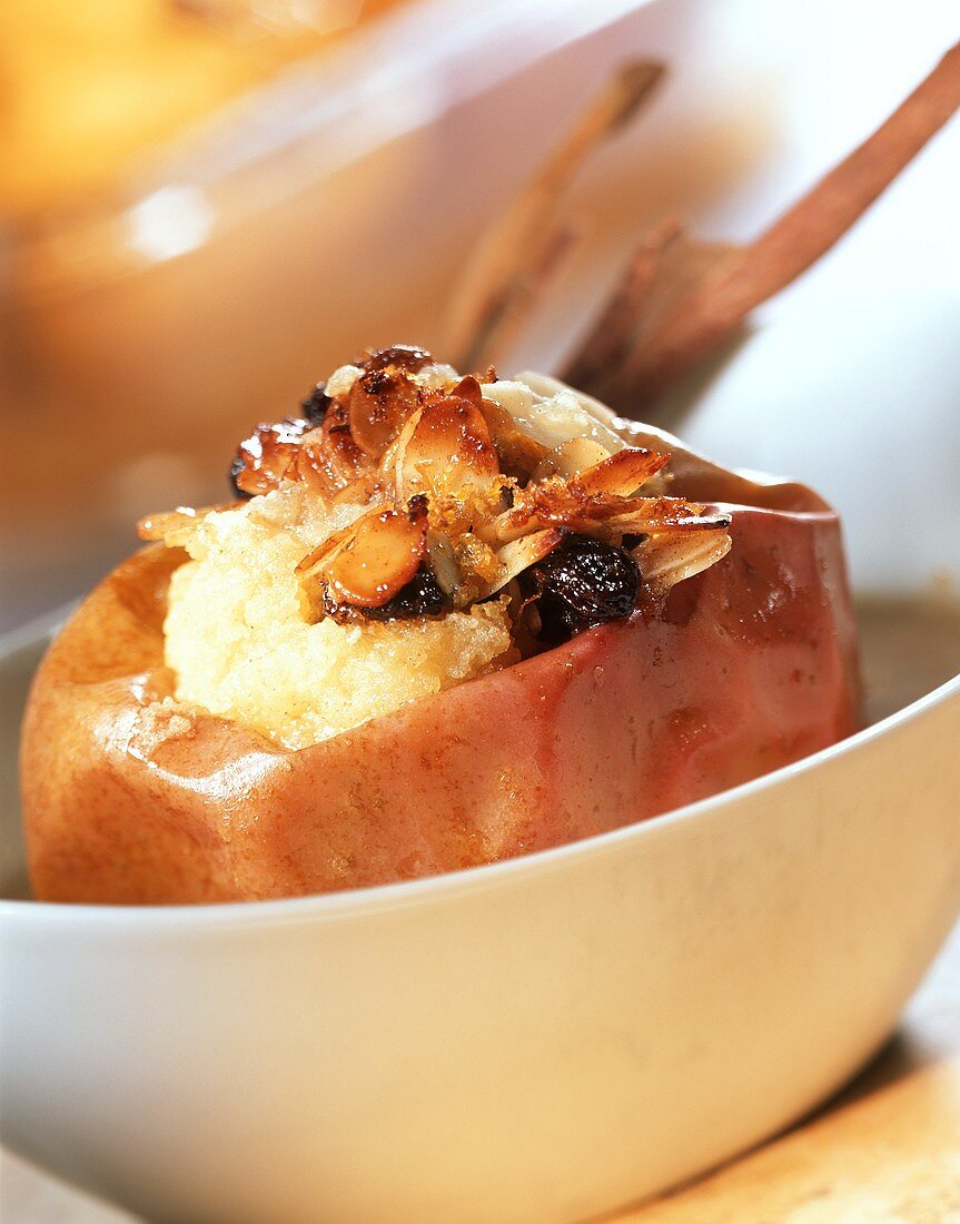 Baked apples with raisins and flaked almonds in a bowl