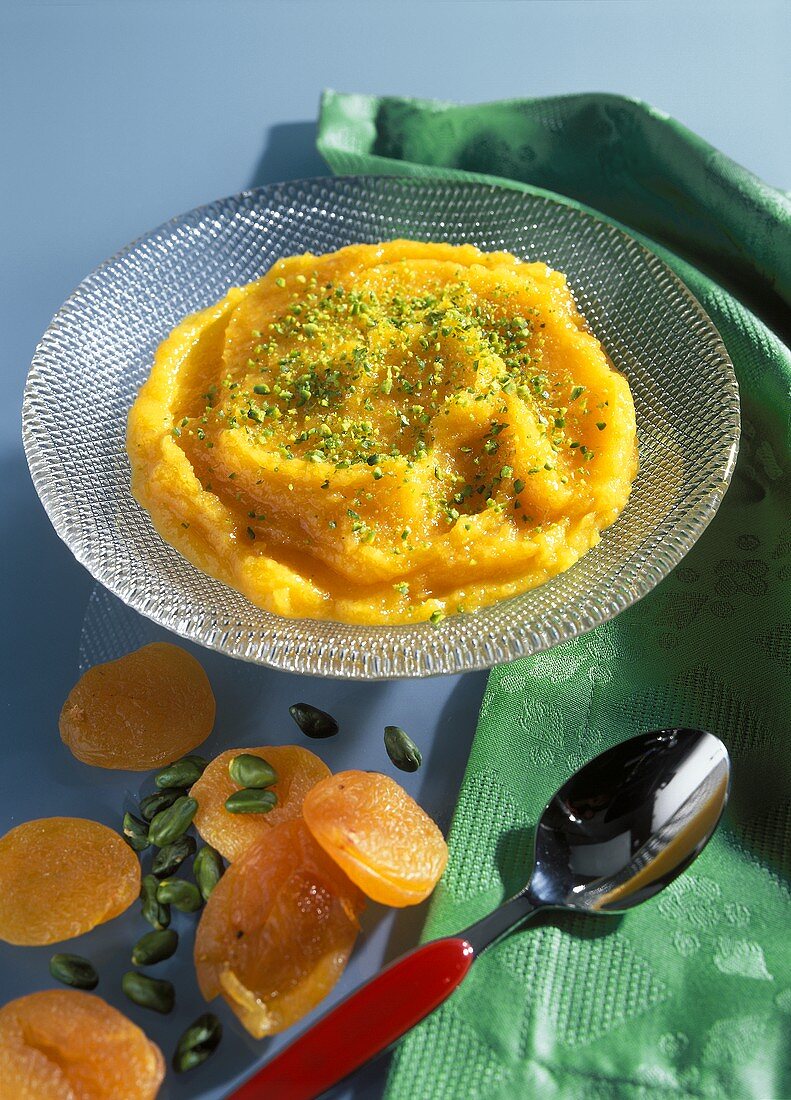 Apricot paste with chopped pistachios in glass bowl