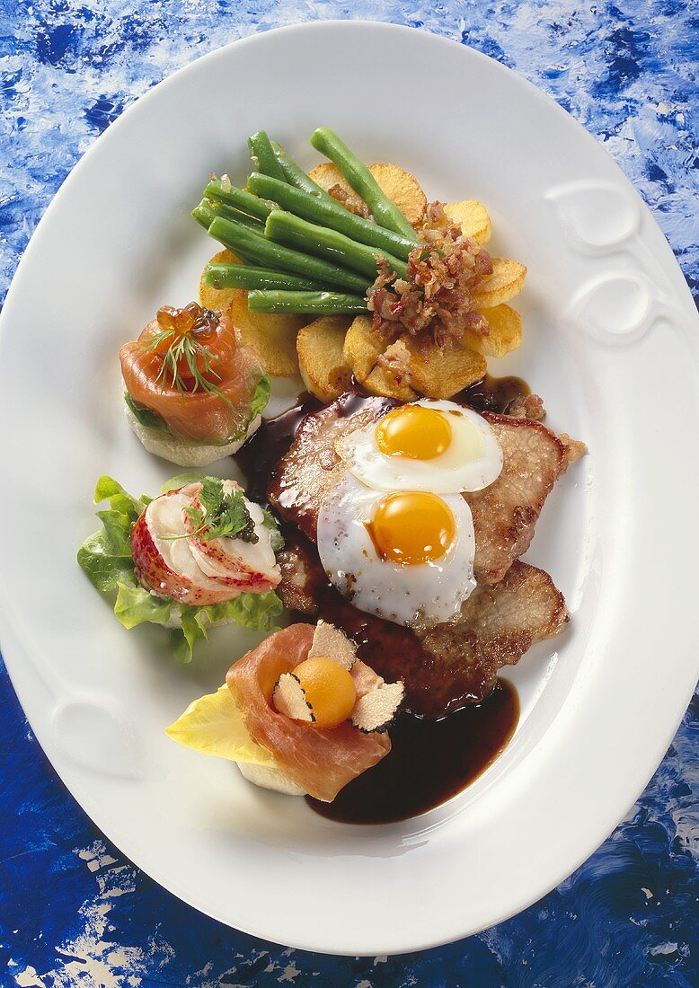 Holstein escalope with fried egg, fried potatoes and canapés