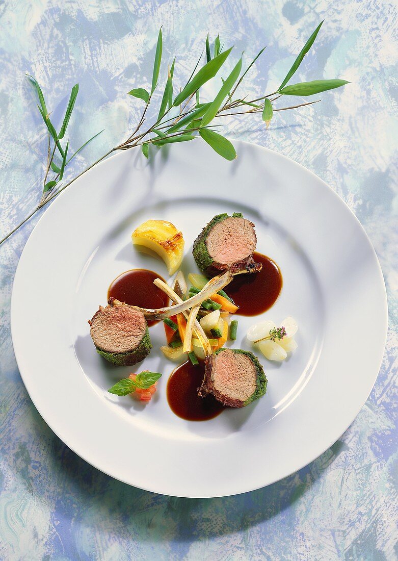 Saddle of lamb in herb crust with vegetables & garlic sauce