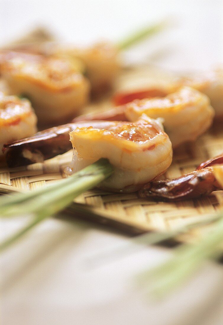 Scampi skewered on lemon grass on bamboo tray