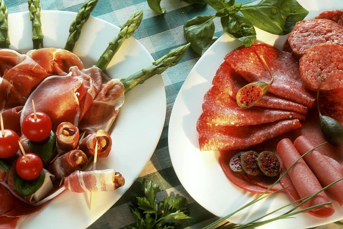 Ham platter with asparagus; sausage platter with caper apples