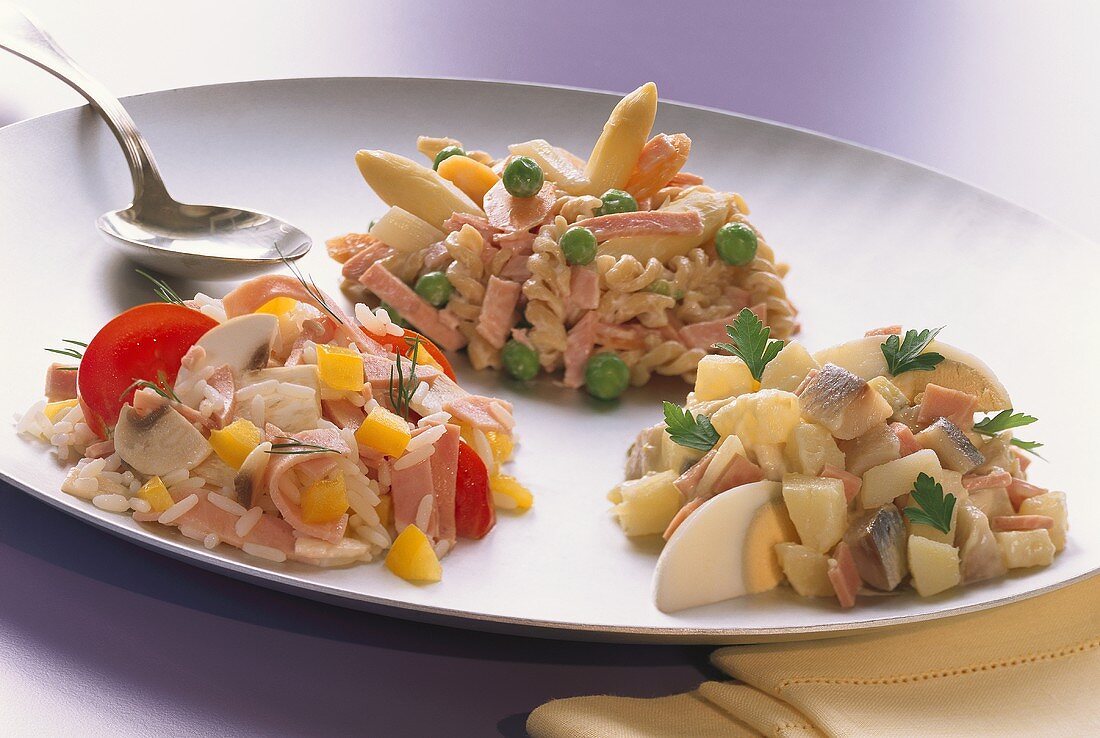 Rice salad, pasta salad and mixed salad on a plate