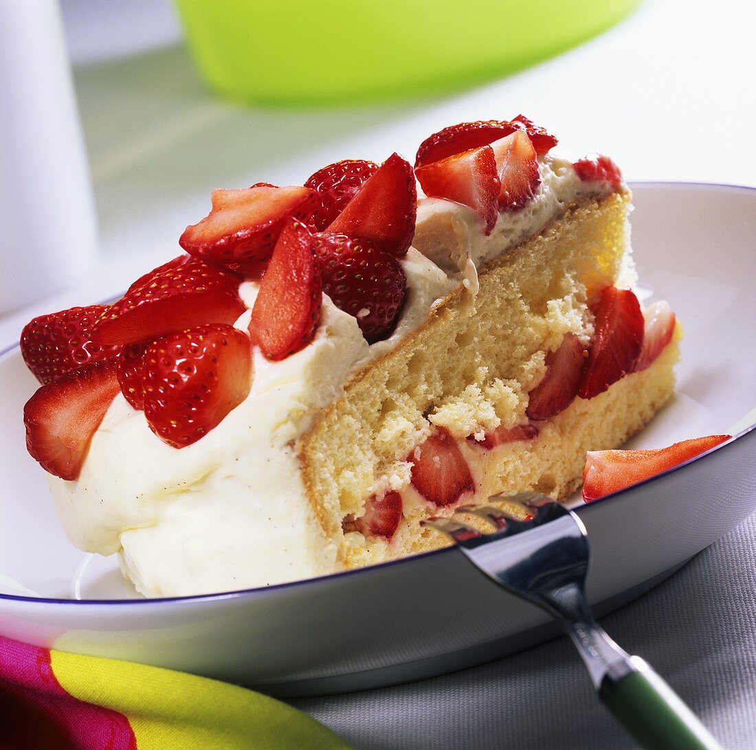 A piece of strawberry cake with vanilla cream