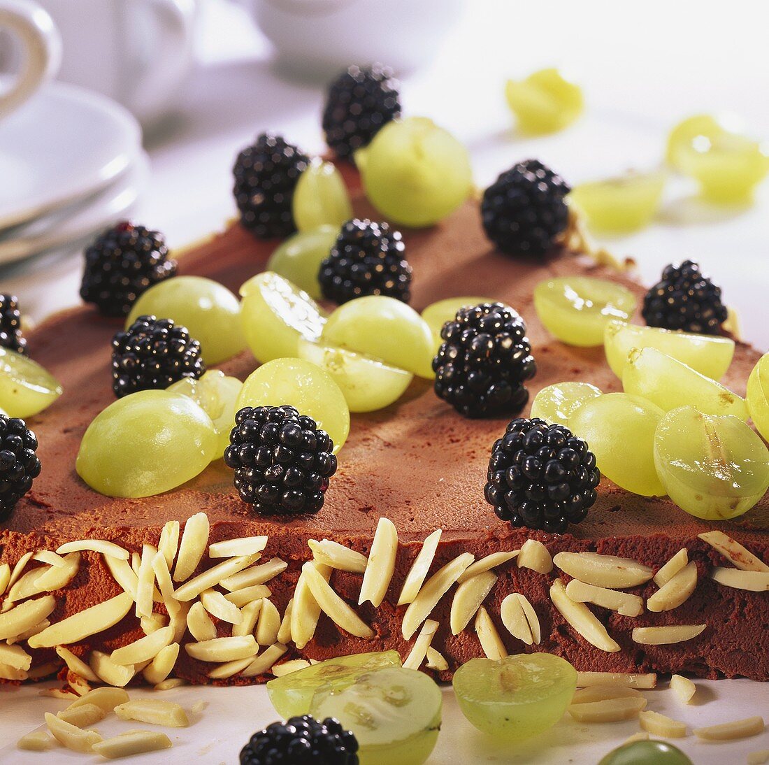 Triangle cake with grapes and blackberries