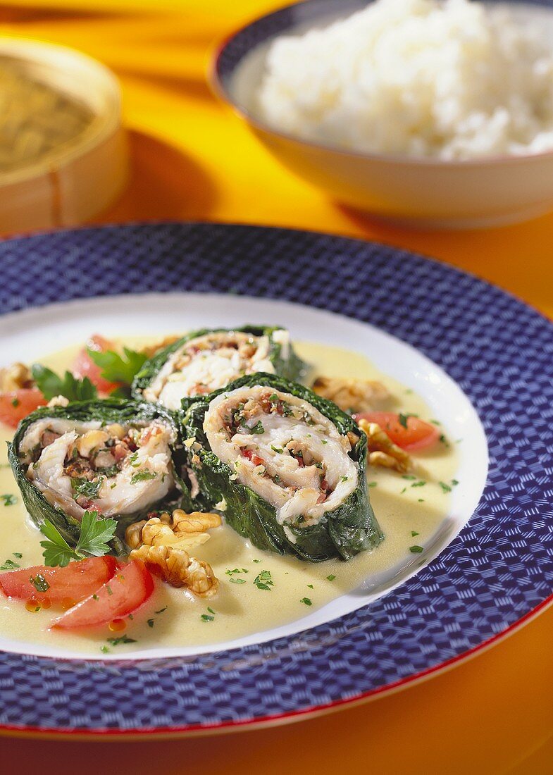 Plaice rolls wrapped in spinach with walnut kernels