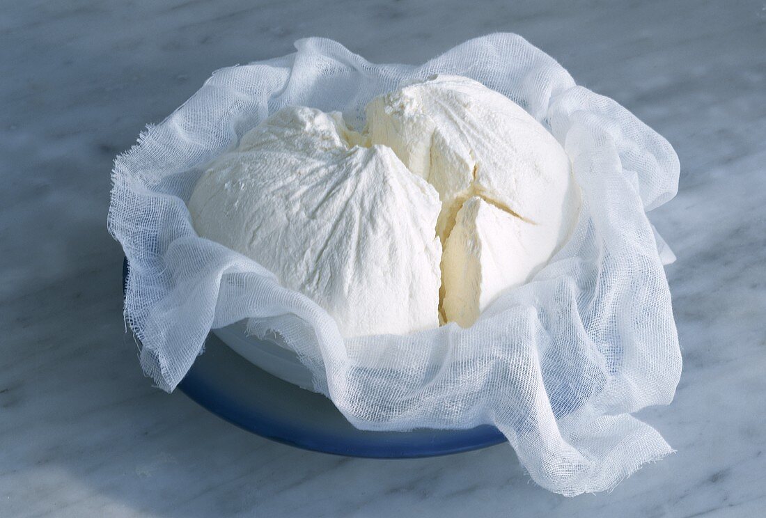 Cream cheese in a bowl with a cloth