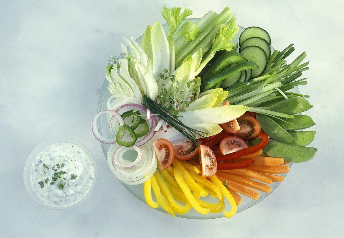 Plate of raw vegetables and herb quark dip