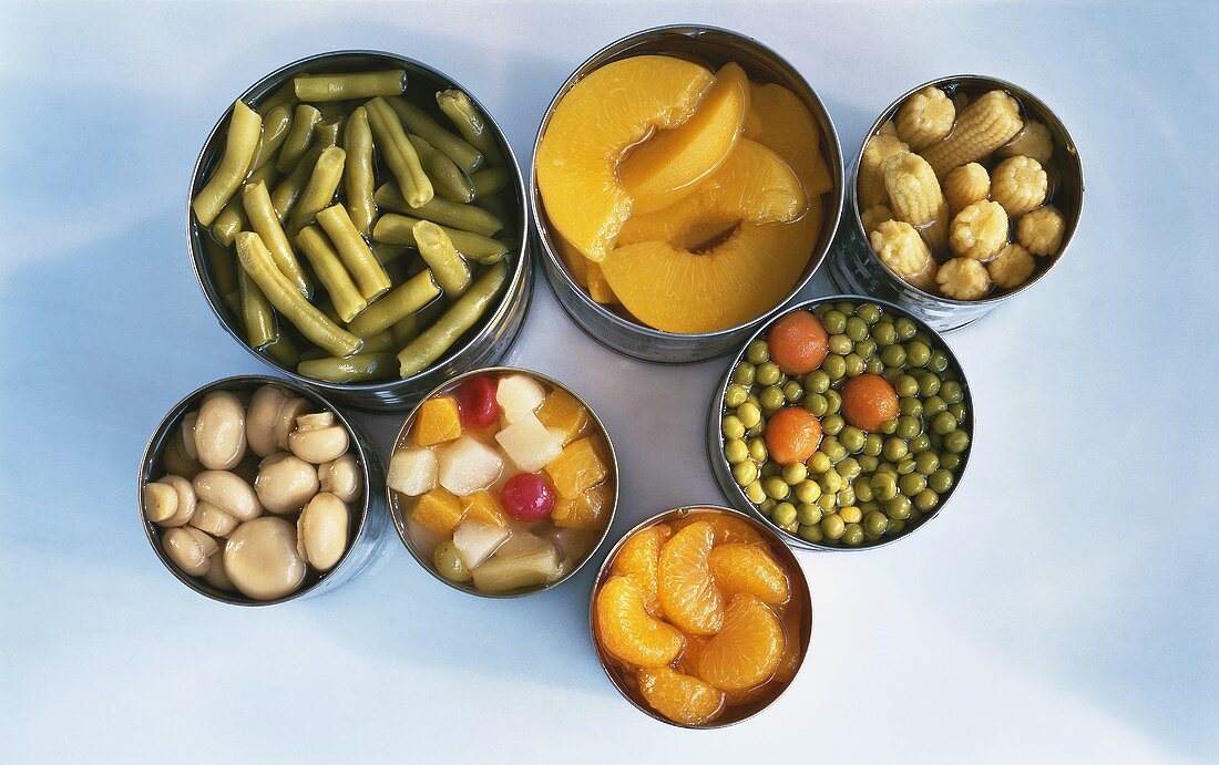 Geöffnete Konservendosen mit Obst und Gemüse