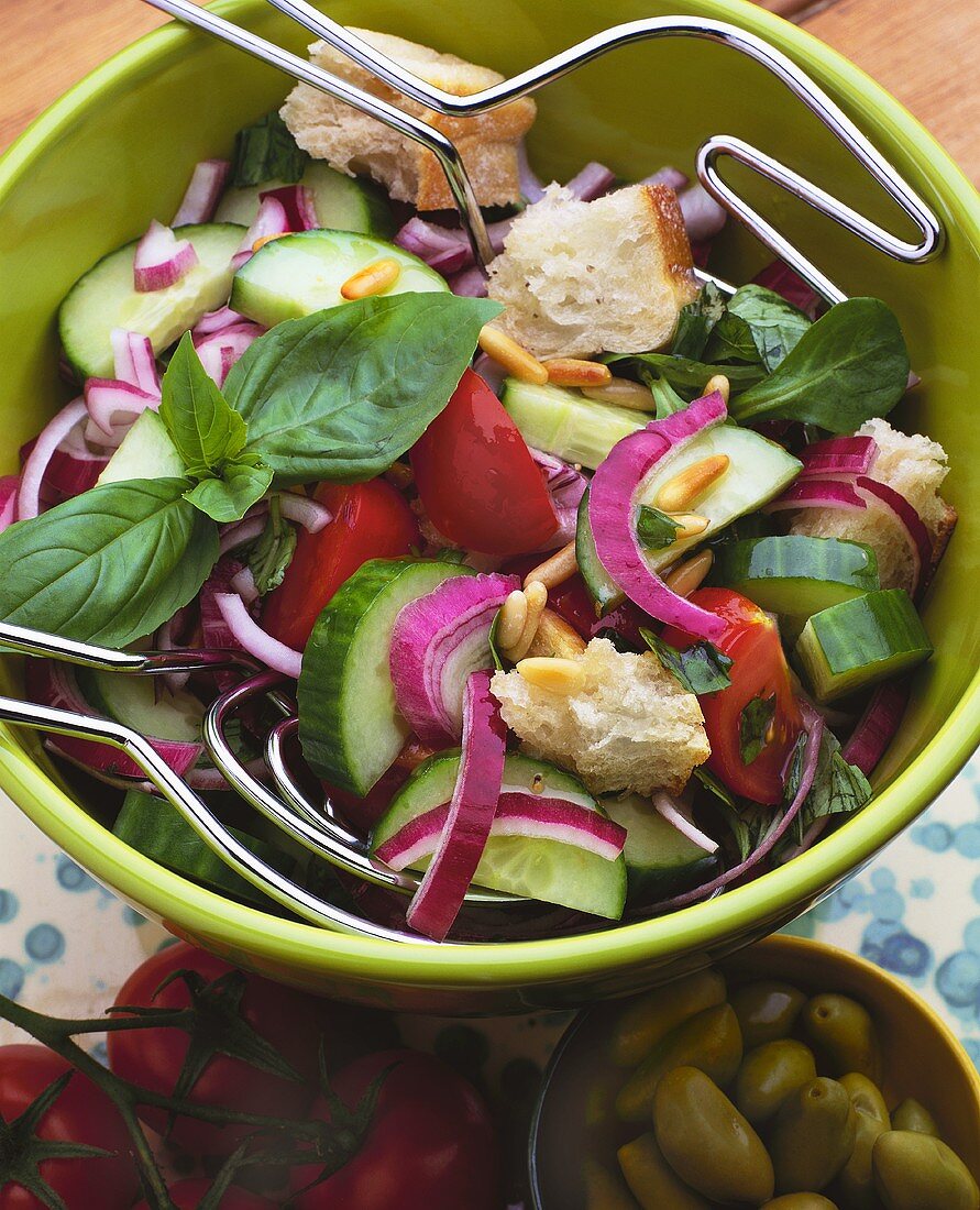 Vegetable salad with cucumber, pine nuts and white bread