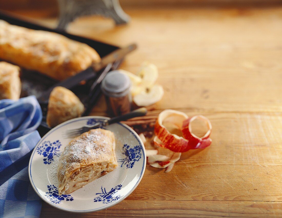 Old Vienna apple strudel on plate and baking sheet