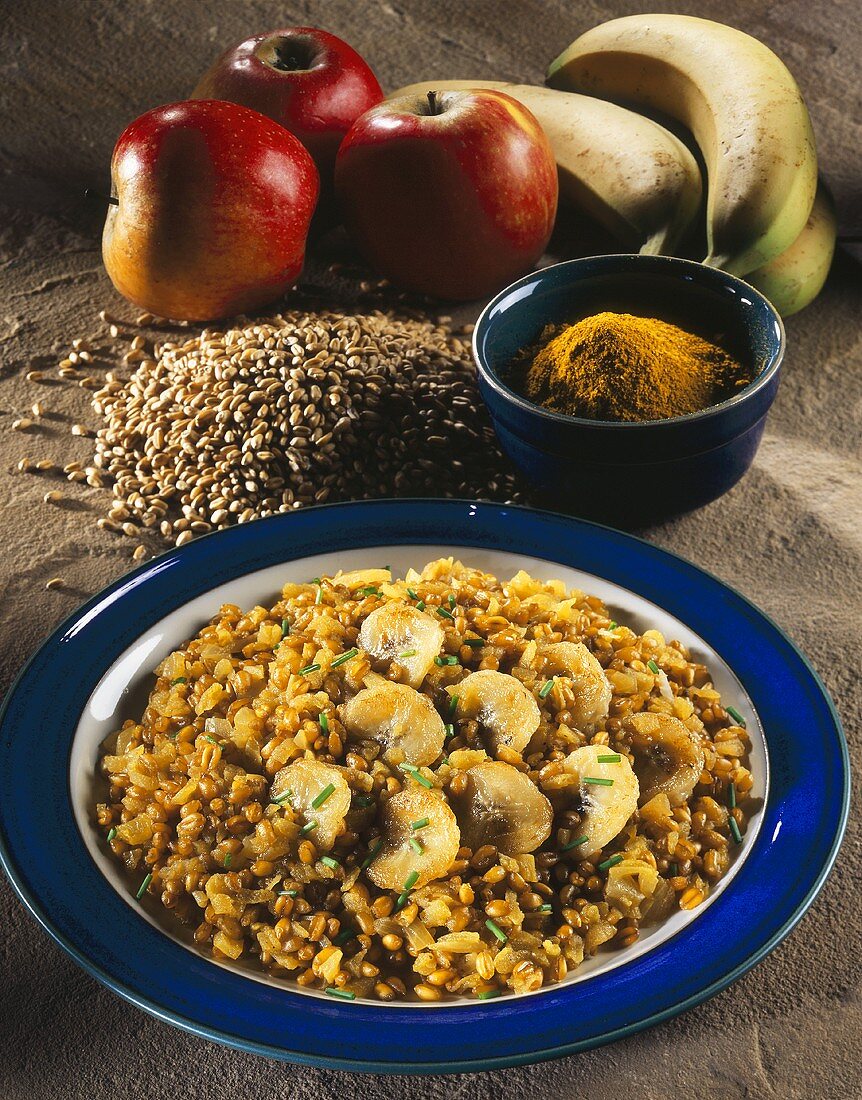 Wheat pilau with curry, apples and bananas