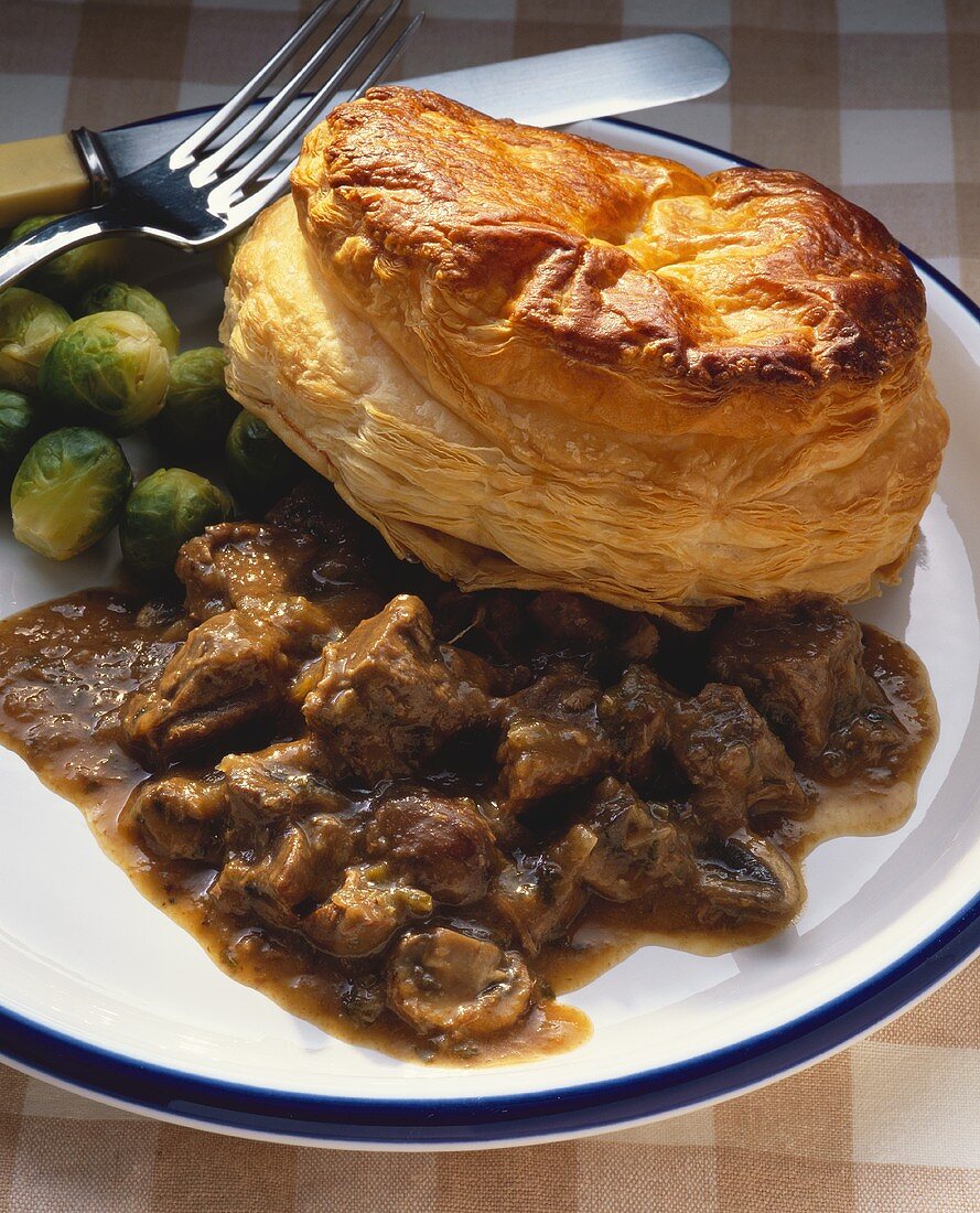 Beef stew with puff pastry and Brussels sprouts