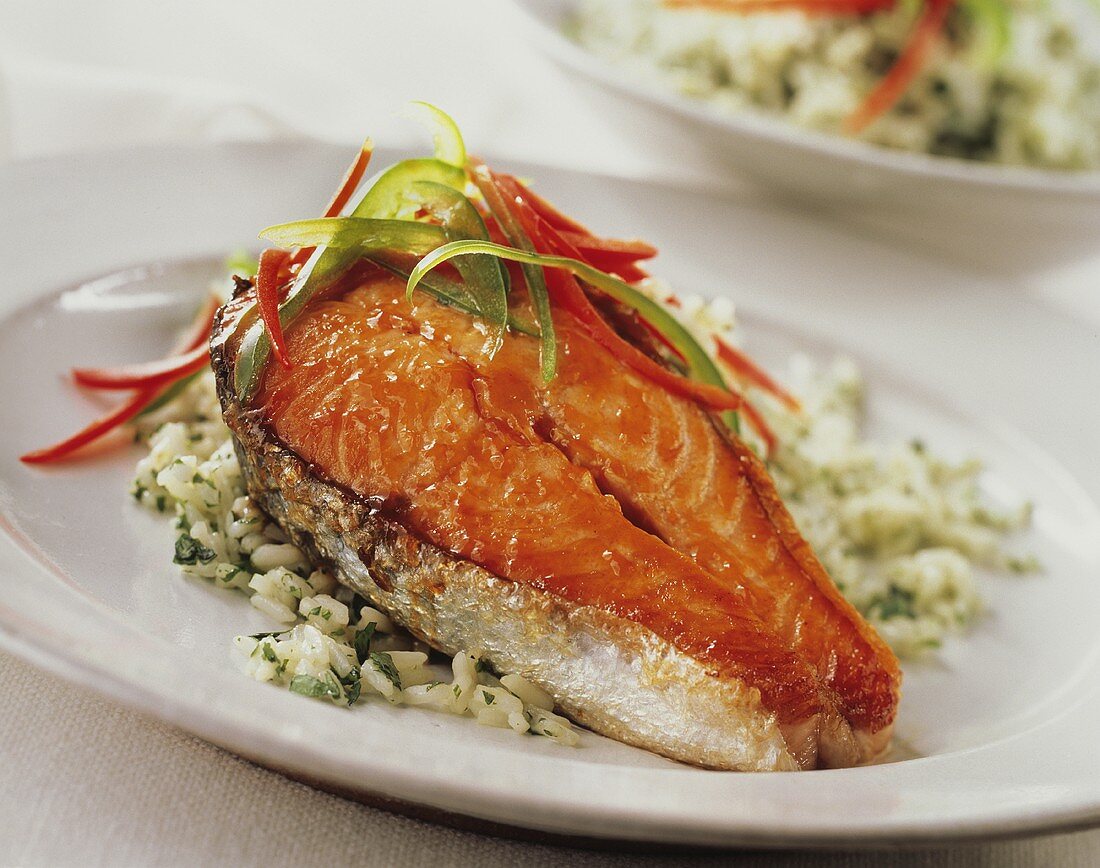 Glazed salmon cutlet with strips of pepper on herb rice