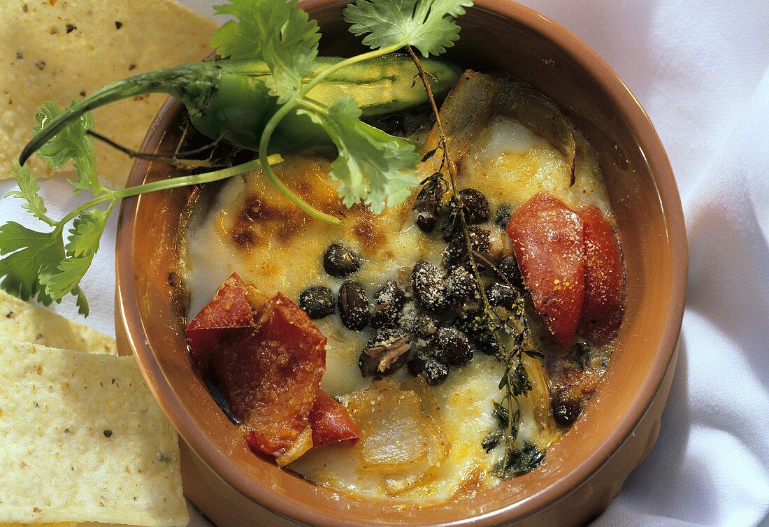 Bean stew au gratin with peppers and tortilla chips