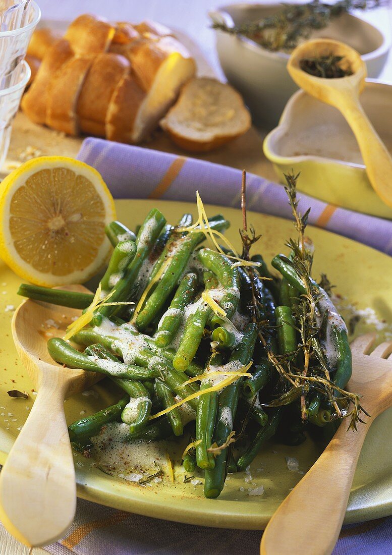 Green beans with lemon sauce and herbs on plate