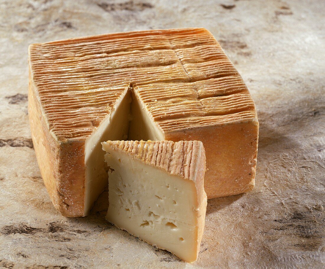 French Maroilles cheese on a light brown background