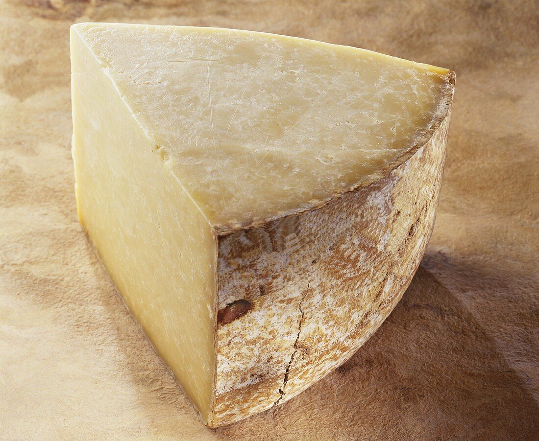 Salers, a French hard cheese, on brown background