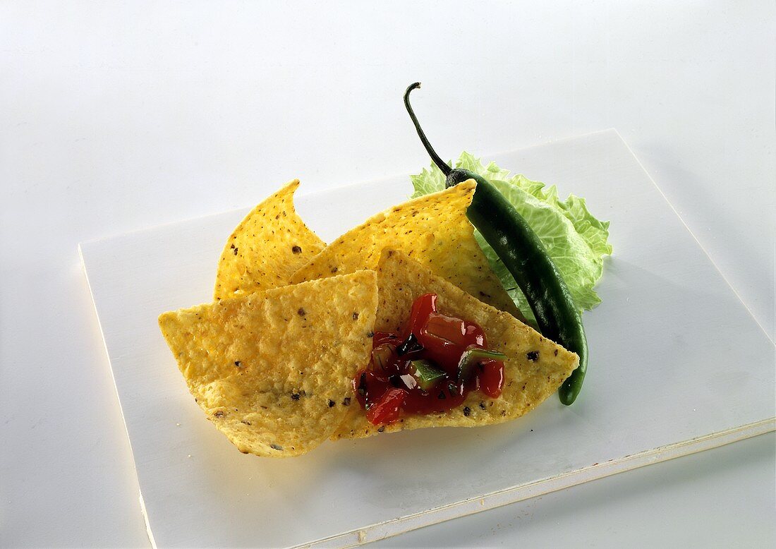 Tortilla chips with salsa and green chili pepper
