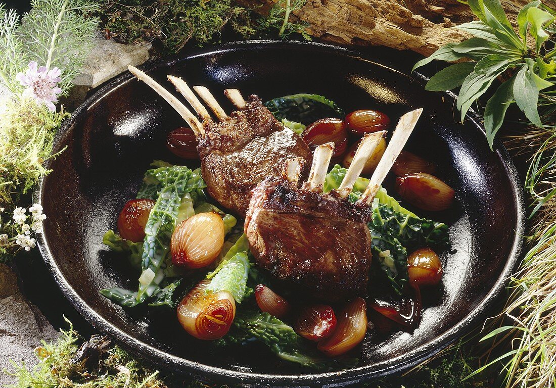 Venison chop with shallots and savoy in a pan