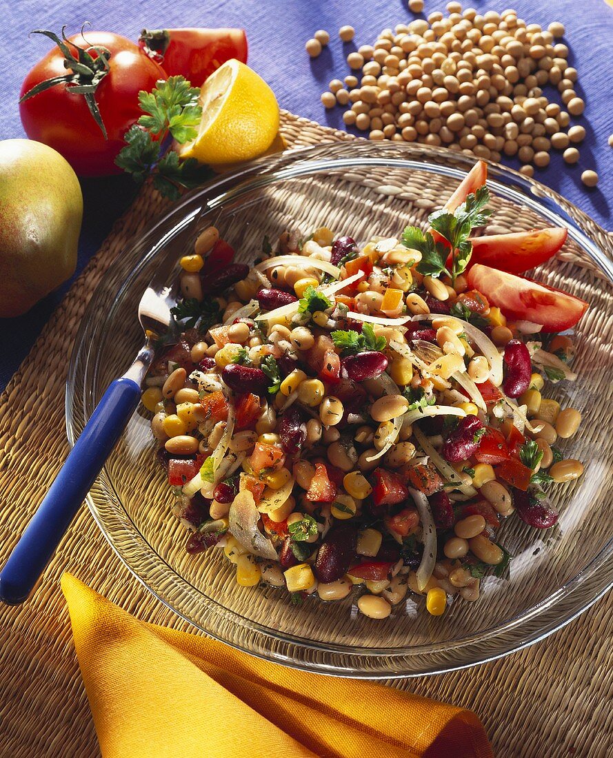 Soya beans with vegetables and parsley on glass plate