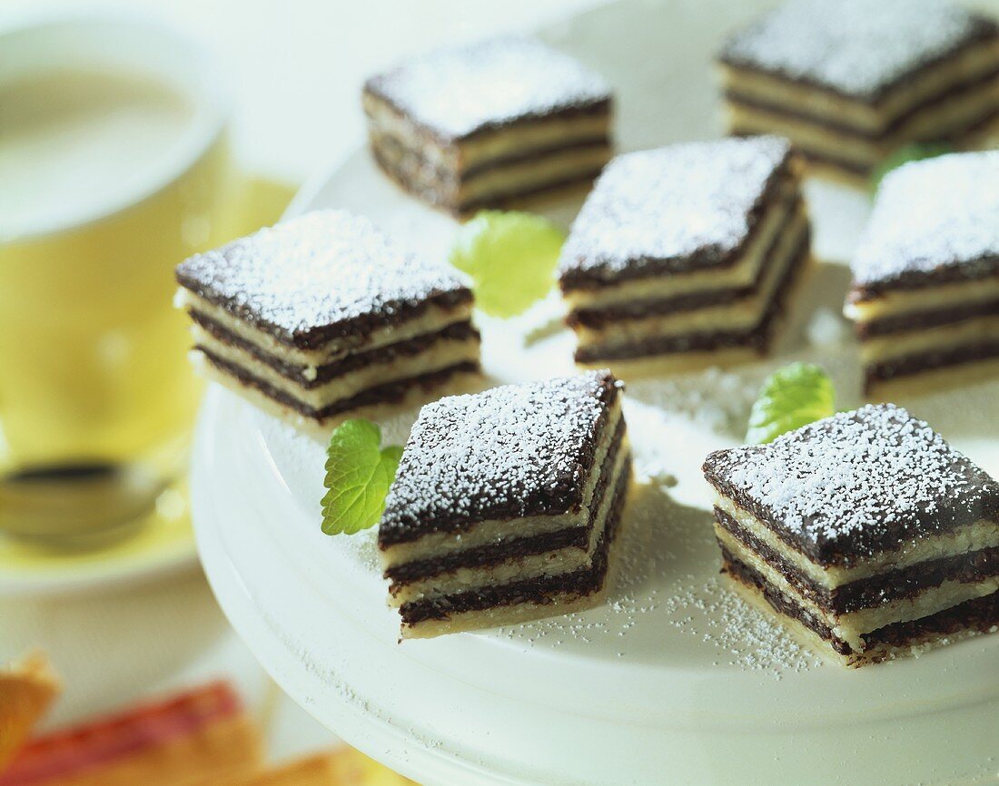 Black and white sweets with icing sugar on a plate