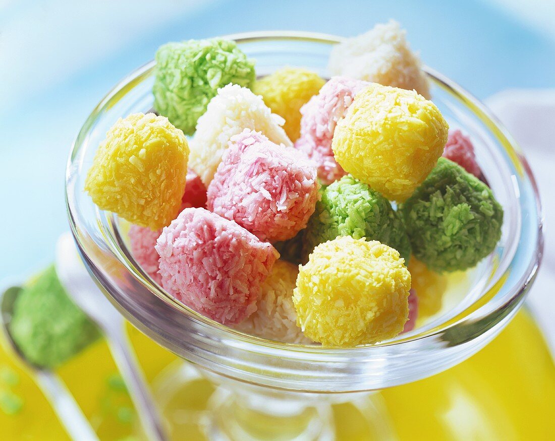 Coloured coconut sweets in glass bowl