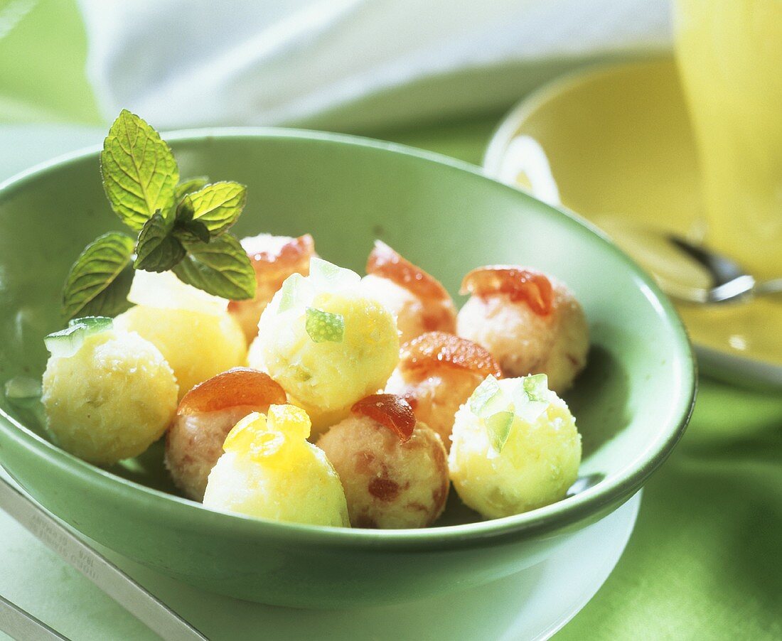 Pineapple sweets with candied fruit in green bowl